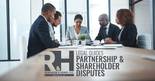 Business shareholders reviewing documents in a meeting