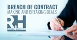 A man is signing a contract to make a deal with another business
