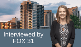 Female attorney in front of skyline of apartments