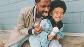 father hugs son as both hold ice cream cones